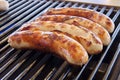 Closeup of the four sausages on the grill