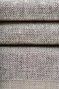 Closeup of a fragment of a beige textile sofa in the room. Texture of expensive fabric on furniture