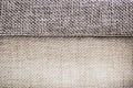 Closeup of a fragment of a beige textile sofa in the room. Texture of expensive fabric on furniture