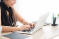 Closeup freelance asian woman working and typing on laptop computer at desk office with professional Royalty Free Stock Photo