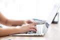 Closeup freelance asian woman working and typing on laptop computer at desk office with professional Royalty Free Stock Photo