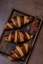 Closeup french chocolate croissant and chocolatier