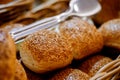 Closeup of fresh baked buns on tray. Buns with sesame seeds served for breakfast on buffet line