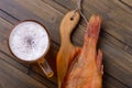 Closeup fresh beer with fish on wooden table in pub Royalty Free Stock Photo