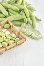 Closeup fresh broad beans on a wooden table Royalty Free Stock Photo