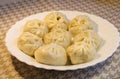 Closeup of fresh Chinese steamed meat buns in white plate, homemade gourmet food Royalty Free Stock Photo