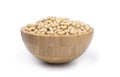 Closeup of fresh dry soybean seed in wooden bowl isolated on white background. Clipping path Royalty Free Stock Photo