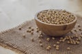 Closeup of fresh dry soybean seed in wooden bowl with spoon on sack Royalty Free Stock Photo