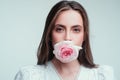 Closeup fresh face girl. Rose flowers in a mouth. Beautiful woman with red rose flower. Pink rose in sensual sexy womans Royalty Free Stock Photo