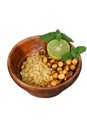 Closeup the fried yellow gram split lentils with black gram and sliced lemon ,mint in the red wooden bowl over out of focus white Royalty Free Stock Photo