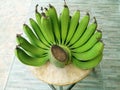 Closeup, Fresh green banana bunch on wood table for background design or stock photo illustration, sweet fruit, healthy food Royalty Free Stock Photo