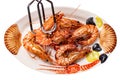 Closeup of fresh grilled large tiger prawns or shrimps on a colourful plate of seafood isolated on a white background. Healthy Royalty Free Stock Photo