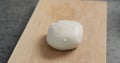 Closeup fresh mozzarella ball on oak board Royalty Free Stock Photo