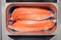 Closeup fresh norwegian salmon fillet fish in metal bowl tray on professional restaurant kitchen. Textured background. Concept Royalty Free Stock Photo