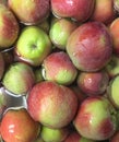 Closeup of fresh organic red and green apples floating in water with water drops.