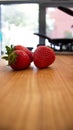 Closeup of fresh organic strawberries on a wooden chopping board