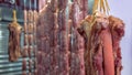 Closeup of fresh raw pig meat hanging in an asian stall. Traditional market