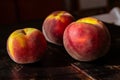Closeup of fresh ripe peaches in season on a wooden table Royalty Free Stock Photo
