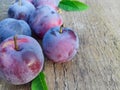 Closeup of fresh ripe plums on a wooden background. Copy space. Fruit background Royalty Free Stock Photo