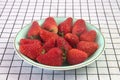 Closeup of fresh ripe red strawberries in bowl on white checkered tablecloth, healthy food Royalty Free Stock Photo