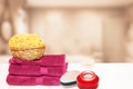 Closeup of fresh soft terry bath towels and soap, shampoo bottles and a basket with a natural sponge on table over blurred Royalty Free Stock Photo