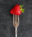 Strawberry on a vintage fork with a patina