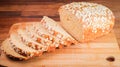 Closeup of the freshly baked sliced oatmeal loaf on a wooden surface