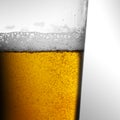 Closeup of freshly poured glass of beer with frothy head and bubbles Royalty Free Stock Photo