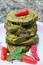 closeup the fried arabic leaves food with red chilly and green mint in the plate soft focus natural grey brown background