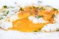 Closeup, fried egg with fluidly and liquid egg yolk on a white p