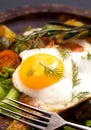 Closeup fried egg and vegetables with fork