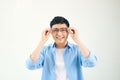 Closeup of friendly guy wearing eyeglasses. Young asian man adjusting glasses and staring at camera through lens. Vision and eye Royalty Free Stock Photo