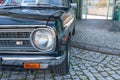 Closeup of the front of a beautiful shiny Nissan Datsun 1200 car