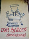 Closeup of In front of the Domestic Automatic Flour Mill Shop written Here we are cleaning and flour making of Ragi, Rice, Wheat