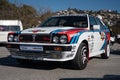 Closeup of the front of a Lancia Delta HF parked on the street