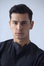 Closeup front portrait of handsome brunette young man in black t shirt,  white background Royalty Free Stock Photo