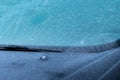 Closeup front view of car parked at outdoor car parking lot that windshield and bonnet covered by freezing rain and small ice Royalty Free Stock Photo