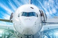 Closeup front view of nose of the passenger airplane and the cockpit glasses of the pilot. Royalty Free Stock Photo