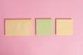 Closeup front view three multicolor blank notepads message sticky notes colored background empty text important events