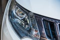 Closeup of front view of a white car modern technology head light with xenon lamp Royalty Free Stock Photo