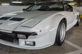 Closeup of the front view of a white vintage Lotus model Esprit car in a garage
