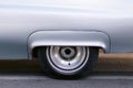 Closeup of the front wheel rim on a silver vintage car Royalty Free Stock Photo