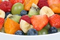 Closeup fruit salad in a bowl with strawberries, blueberries and