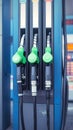 Closeup fuel nozzles dispensing petrol and diesel at station