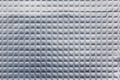 Closeup full-frame background and texture of aluminum coated butil rubber sheet with square pattern. Royalty Free Stock Photo