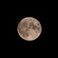 Closeup of the full moon with several craters visible on a dark background Royalty Free Stock Photo