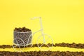 Closeup of a funny bicycle bowl with coffee beans on a yellow background Royalty Free Stock Photo