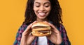 Closeup Of Funny Black Lady Holding Burger At Studio Royalty Free Stock Photo