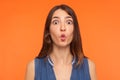 Closeup of funny stupid brunette woman making fish face, looking with big amazed shocked eyes and idiotic silly expression Royalty Free Stock Photo