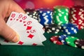 Closeup of gambler hand takes playing cards in poker club. Poker cards with straight combination